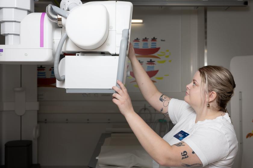 A radiographer adjusting an X-ray machine.