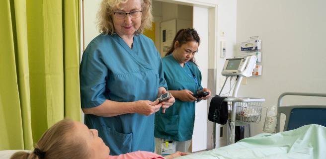 Sängyssä makaavaa potilasta hoidetaan osastolla