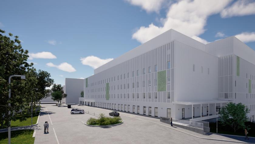 kuusikerroksinen vaalea rakennus, jonka julkisivussa grafiikkaa muutamassa heleän vihreässä suuressa ruudussa