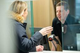 A lobby attendant talks with a customer.